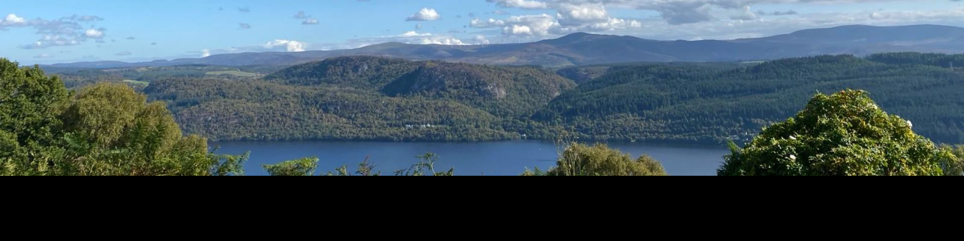 Image of a view looking out on Loch Ness on a sunny day