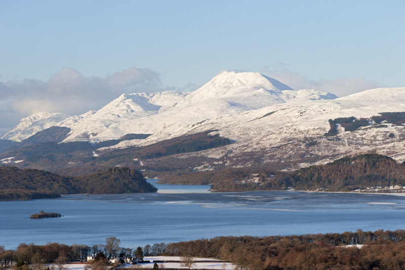 Looking north to snowy Ben Lomond and the other mountains around Loch Lomond in the evening light. Credit: iStock-theasis.