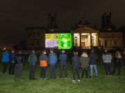 Students from the winning team from Kemnay Academy and Scottish Land Commission staff and Commissioners watch the winning film projected onto the Scottish National Gallery of Modern Art building. Credit: Adam Kenrick.